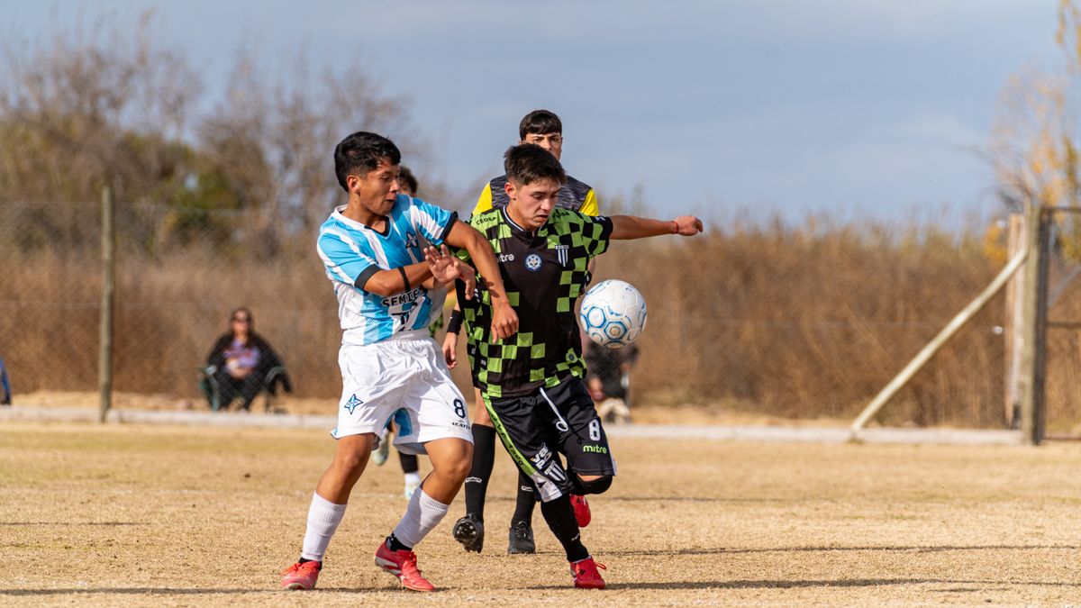 Two young soccer players competing for the ball on a sunny field. Two young soccer players competing for the ball on a sunny field.