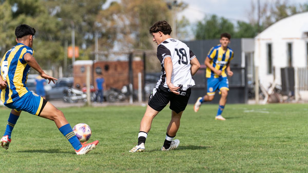 Dynamic action shot of a youth soccer match during the day on a grassy field. Dynamic action shot of a youth soccer match during the day on a grassy field.