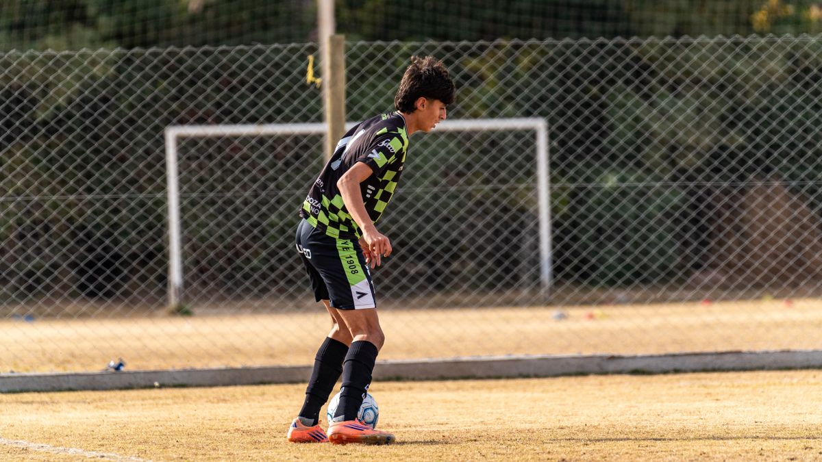 Teen soccer player in action on an outdoor field, focusing on ball control. Teen soccer player in action on an outdoor field, focusing on ball control.