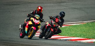 Two motorcyclists racing on a track in Rosario, Calabarzon, Philippines.