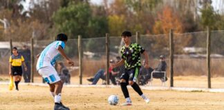 Two young soccer players in action during a thrilling outdoor match.