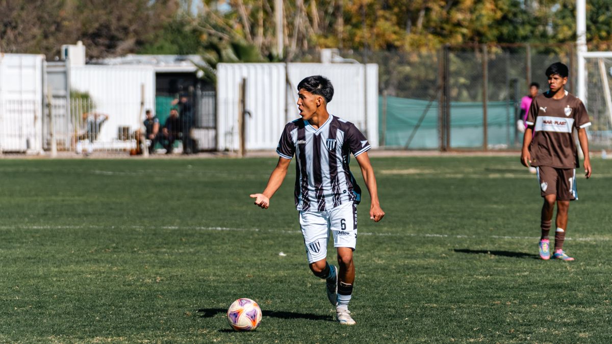Young male soccer players competing on a sunny outdoor field. Young male soccer players competing on a sunny outdoor field.