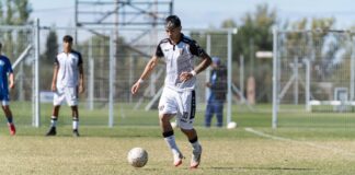 Youth soccer match showcasing players in action on a sunny day.