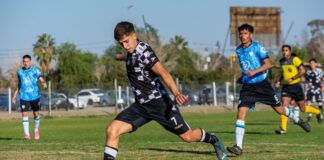 Energetic soccer match with young athletes in action on a bright and sunny day outdoors.