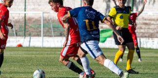 Exciting soccer match capturing competitive play between players in red and blue jerseys.