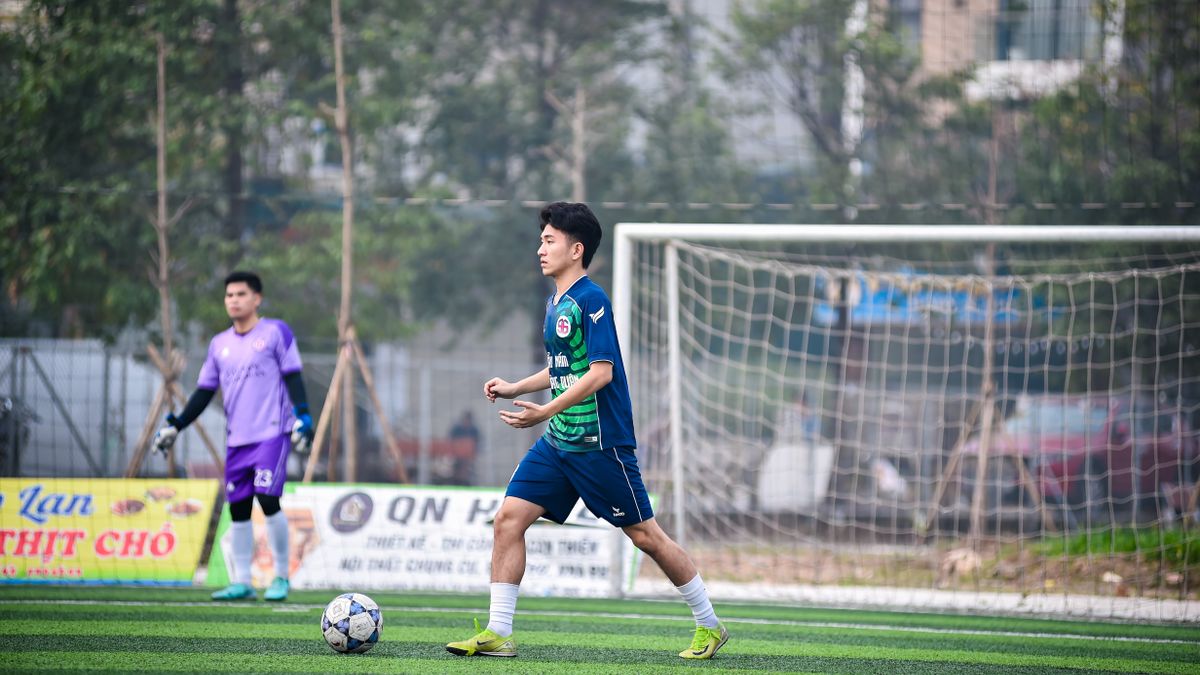 Two soccer players in action on a grassy field in Hanoi, Vietnam, showcasing teamwork and sportsmanship. Two soccer players in action on a grassy field in Hanoi, Vietnam, showcasing teamwork and sportsmanship.