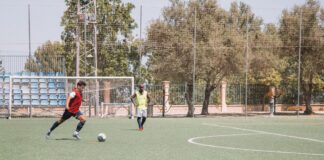Two soccer players practicing on an outdoor pitch in Málaga, Spain.