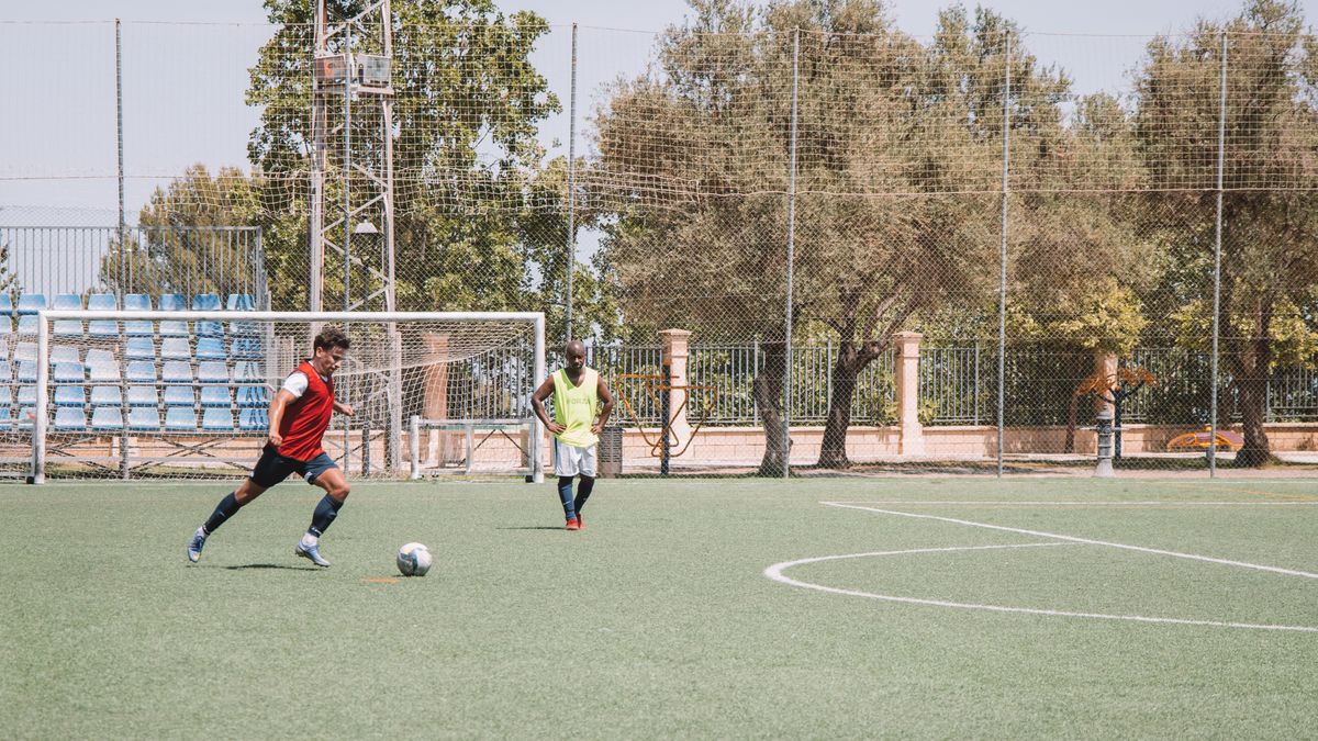 Two soccer players practicing on an outdoor pitch in Málaga, Spain. Two soccer players practicing on an outdoor pitch in Málaga, Spain.