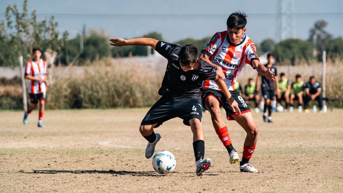 Young soccer players competing fiercely during a sunny day match on an outdoor field. Young soccer players competing fiercely during a sunny day match on an outdoor field.