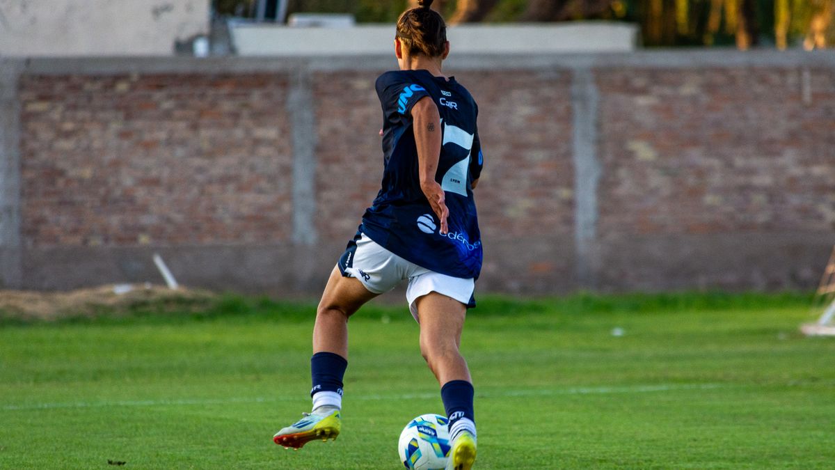 Soccer player in mid-motion on a grassy field, showcasing athletic skill and focus. Soccer player in mid-motion on a grassy field, showcasing athletic skill and focus.