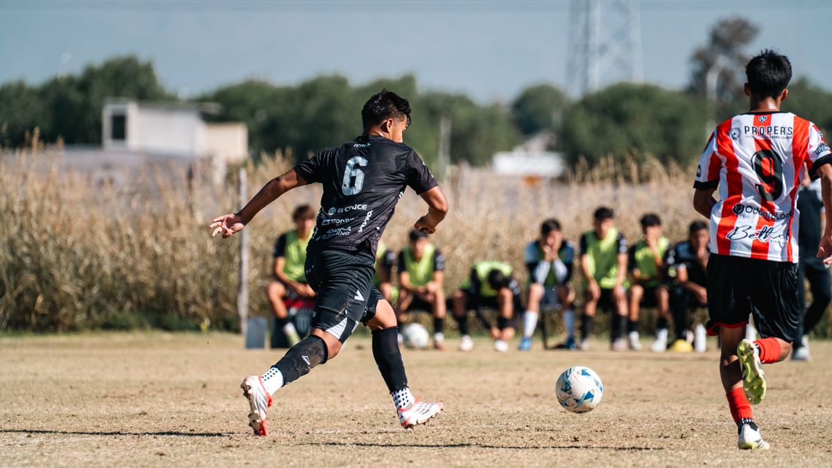 Action shot of youth soccer game with players on field and bench in background. Action shot of youth soccer game with players on field and bench in background.