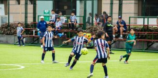 Energetic youth soccer players in action on a vibrant green field.