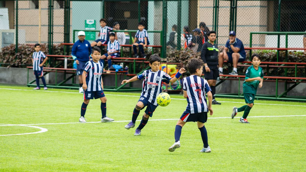 Energetic youth soccer players in action on a vibrant green field. Energetic youth soccer players in action on a vibrant green field.