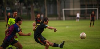 Players in action during a competitive outdoor soccer match.