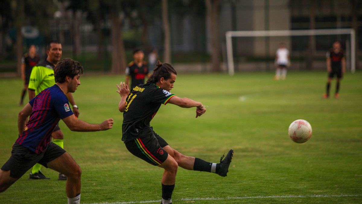Players in action during a competitive outdoor soccer match. Players in action during a competitive outdoor soccer match.