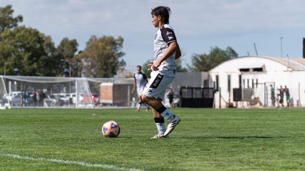 Dynamic action shot of a soccer player mid-game on a sunny day. Dynamic action shot of a soccer player mid-game on a sunny day.