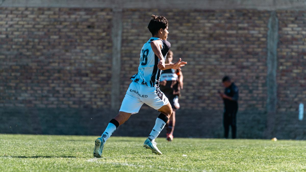 Dynamic shot of a young soccer player in mid-action during a game outdoors. Dynamic shot of a young soccer player in mid-action during a game outdoors.