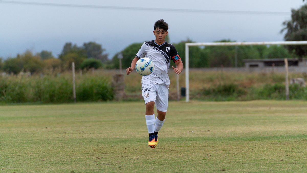 Teenager playing soccer on a grassy outdoor field, showcasing sportsmanship and athleticism. Teenager playing soccer on a grassy outdoor field, showcasing sportsmanship and athleticism.