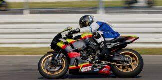 Dynamic shot of a superbike racer speeding on Hockenheim circuit in Germany.
