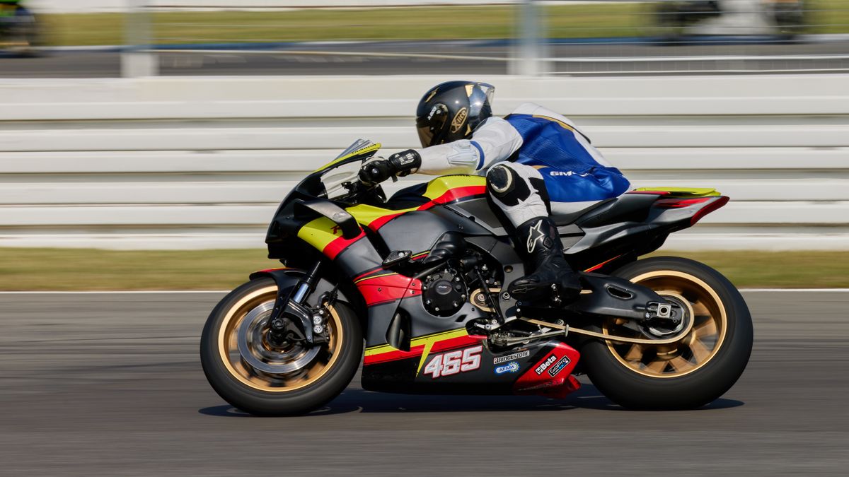 Dynamic shot of a superbike racer speeding on Hockenheim circuit in Germany. Dynamic shot of a superbike racer speeding on Hockenheim circuit in Germany.