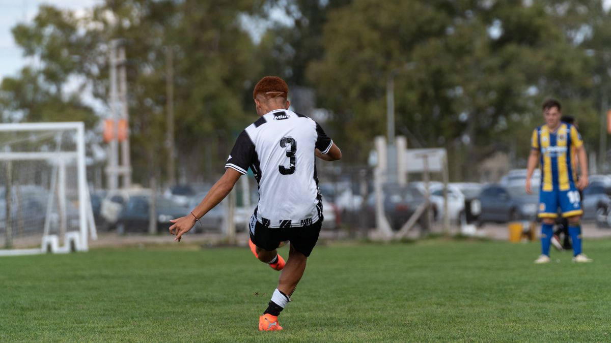 Action shot of football player kicking ball during a match on an outdoor field. Action shot of football player kicking ball during a match on an outdoor field.