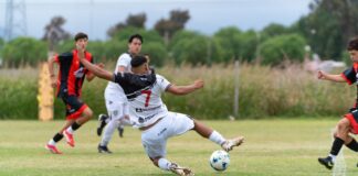 Exciting action moment during a youth soccer match, players competing outdoors.
