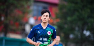 Football player on field in Hà Nội, showcasing athletic skills.
