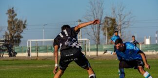 Captured intense moment during a soccer match under clear skies.