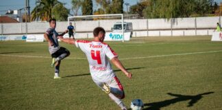 Dynamic shot of players engaged in a competitive soccer match outdoors.