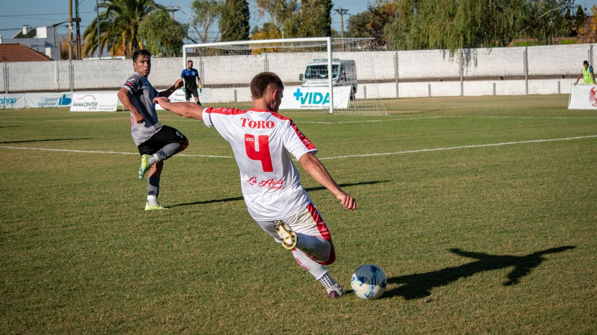 Dynamic shot of players engaged in a competitive soccer match outdoors. Dynamic shot of players engaged in a competitive soccer match outdoors.