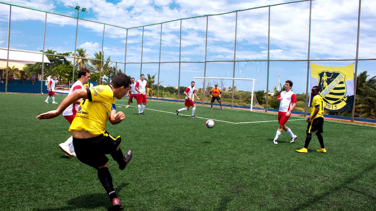 Dynamic soccer match with players in action on a bright sunny day. Dynamic soccer match with players in action on a bright sunny day.