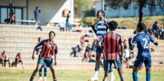Energetic youth soccer game capturing players in action on a sunny day.