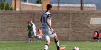 Soccer player in action on field during outdoor match, focusing on skillful play.