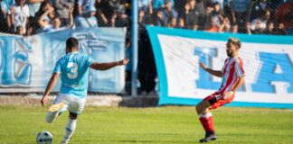 Action-packed soccer match with players in blue and red uniforms competing fiercely on the field.