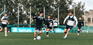 Players engage in a dynamic soccer match on a lush green field, showcasing skill and teamwork.