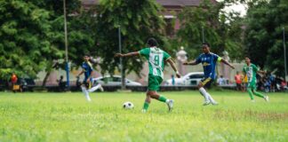 Dynamic soccer game played on a grassy field with enthusiastic players in action.