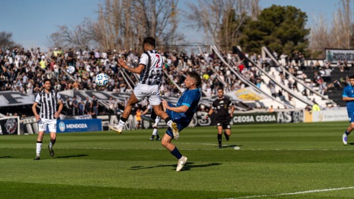 Dynamic scene of players in action during a soccer match at a crowded stadium. Dynamic scene of players in action during a soccer match at a crowded stadium.