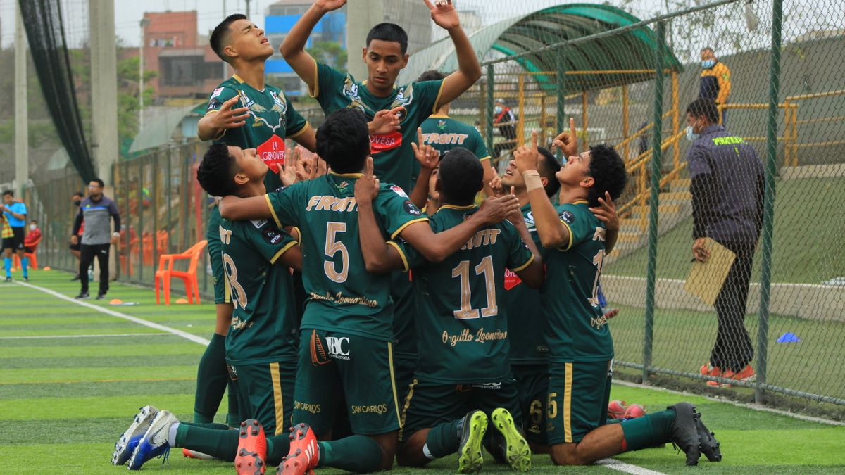 Youth soccer team members celebrate a goal on the field, showing teamwork and excitement. Youth soccer team members celebrate a goal on the field, showing teamwork and excitement.