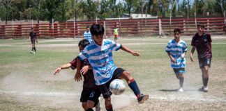 Intense moment in a youth soccer match on a sunny day with players in action.