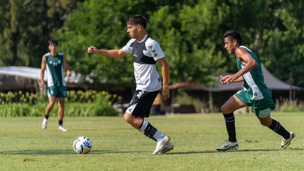 Young male soccer players in action during a competitive outdoor match on a sunny day. Young male soccer players in action during a competitive outdoor match on a sunny day.