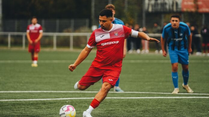 Football player in action on the pitch, showcasing athletic skill. Football player in action on the pitch, showcasing athletic skill.